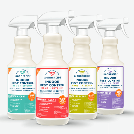Four bottles of Wondercide Indoor Pest Control for Home + Kitchen with Natural Essential Oils in cedarwood, peppermint, lemongrass, and rosemary scents, side by side. Each bright label highlights pet-safe indoor protection.