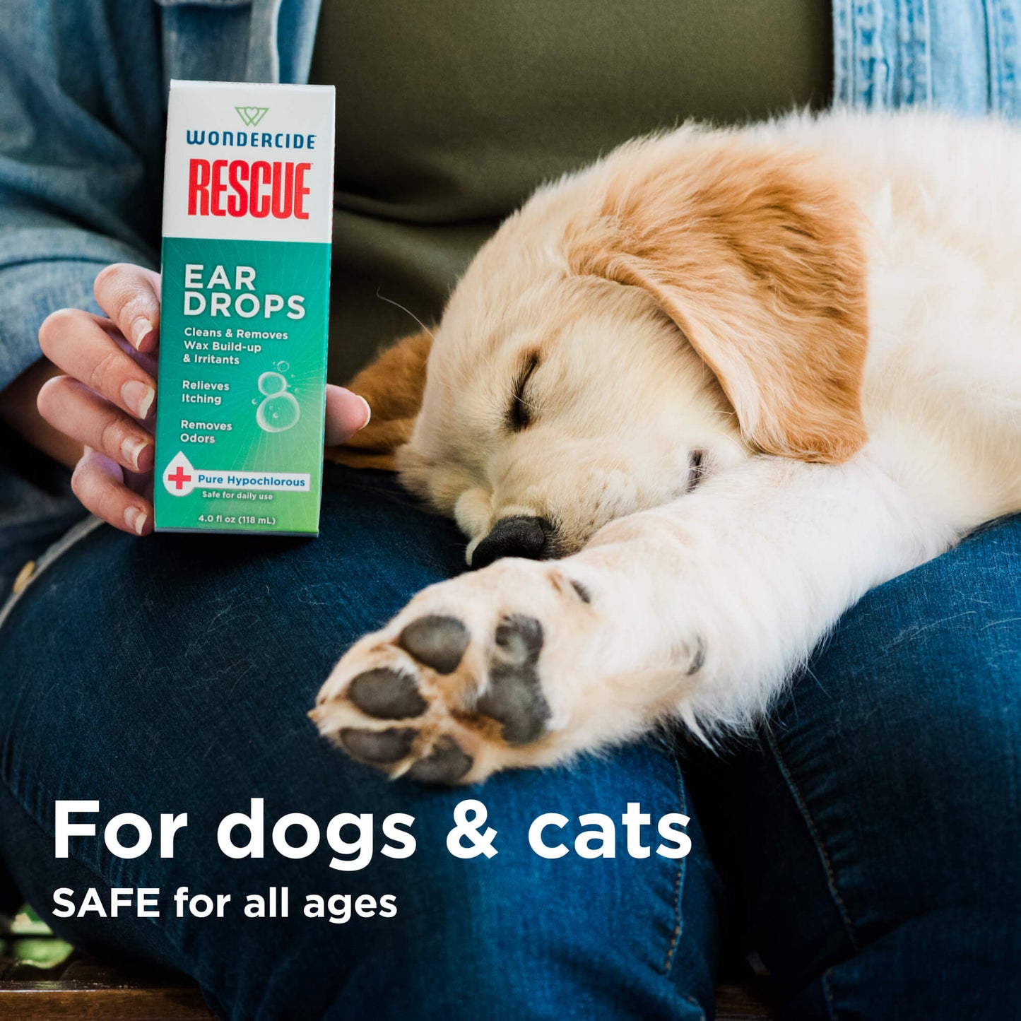 A person holds a box of Wondercide RESCUE™ Ear Drops for Dogs & Cats, which soothes ear irritations and removes wax, next to a sleeping golden retriever puppy on their lap. Text: For dogs & cats. SAFE for all ages.