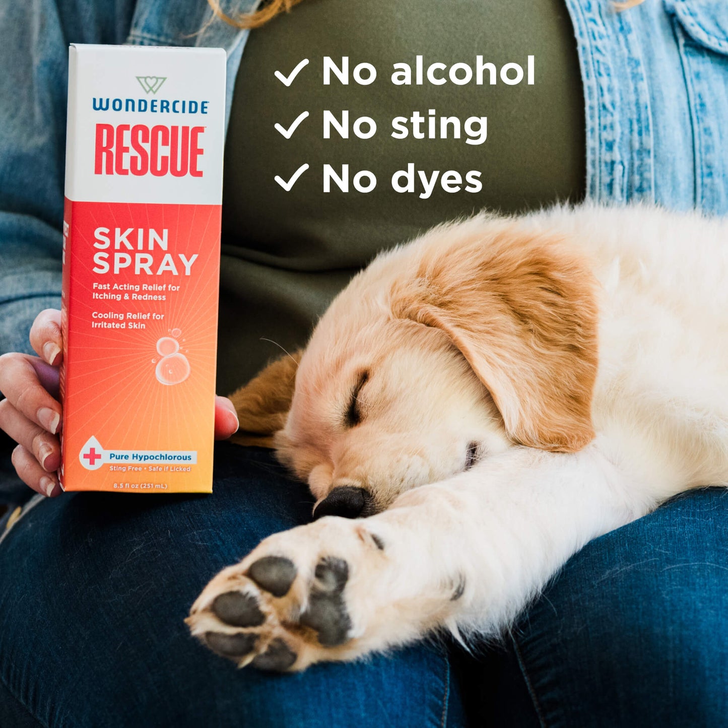 A person holds a Wondercide RESCUE™ Skin Spray for Dogs & Cats box beside a sleeping golden retriever puppy. Text reads: No alcohol, no sting, no dyes—gentle relief for irritated skin.