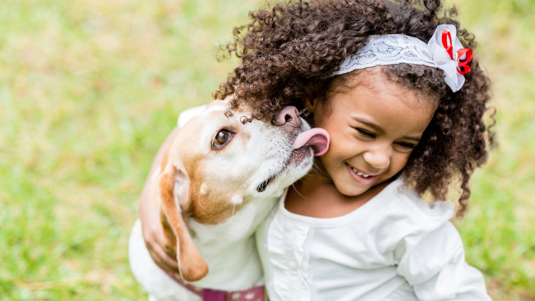 a dog licking a girl's face