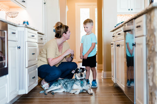 mother in kitchen with son and dog