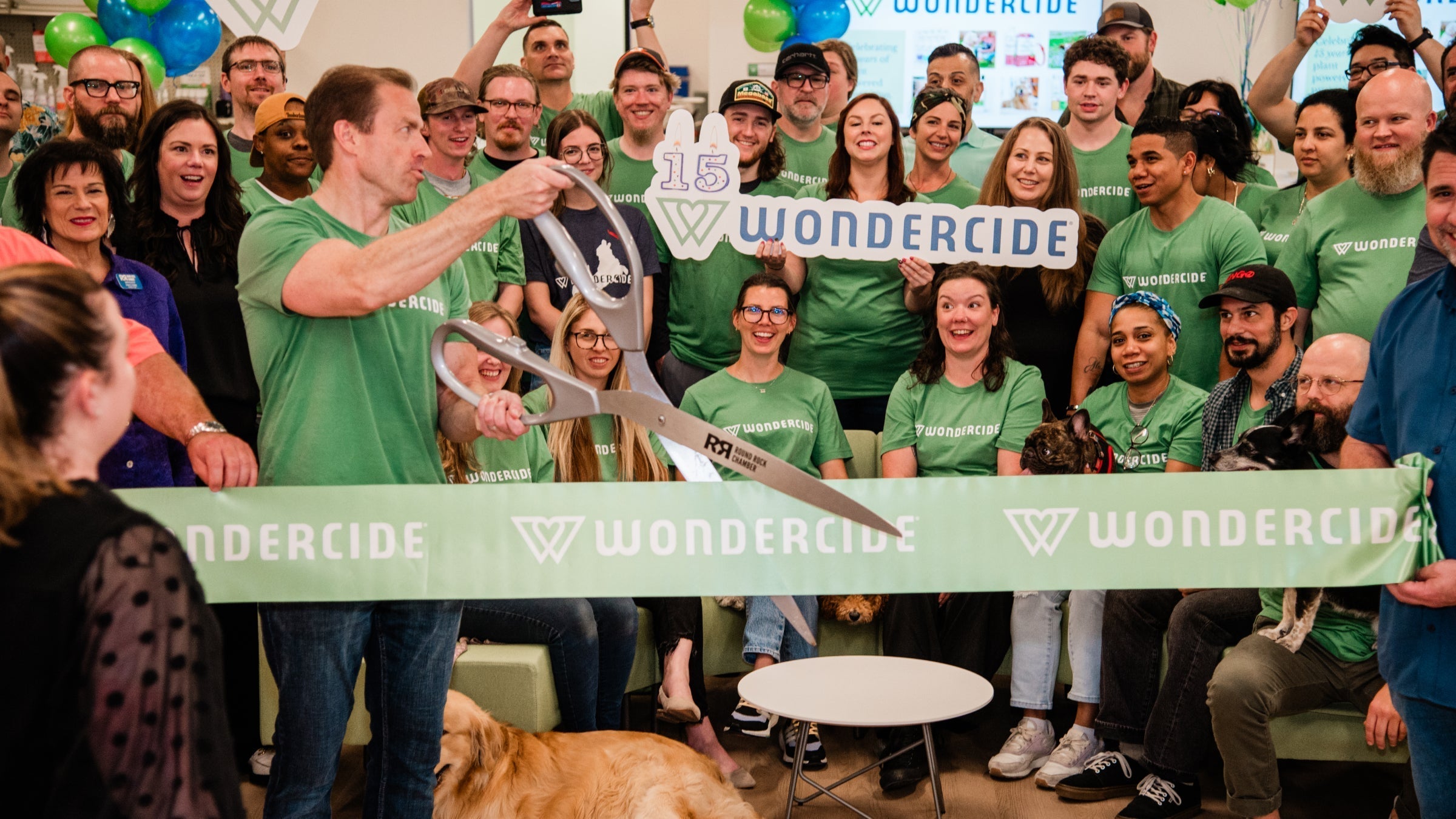 Wondercide team celebrating their 15th anniversity with a ribbon cutting ceremony 
