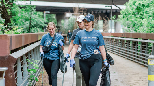 Wondercide employees pick up litter on Earth Day along the hike and bike trail in Austin Texas