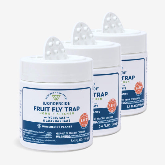 Three white containers of Wondercide Fruit Fly Trap for Home + Kitchen are displayed in a row, showing plant-powered blue and orange labels. These traps work quickly against fruit flies, last 21 days, and are safe for your space.
