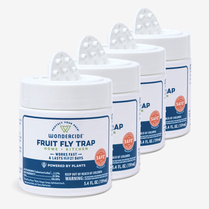 Four Wondercide Fruit Fly Trap for Home + Kitchen containers, each with a vented white lid and labeled for home and kitchen use, are lined up diagonally. They effectively trap fruit flies for up to 21 days.