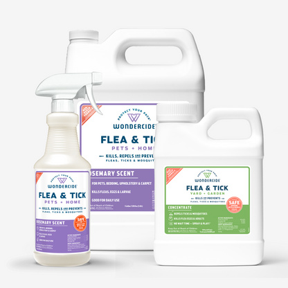 Three bottles from Wondercides Home Treatment Kit display flea & tick sprays with natural essential oils: one rosemary-scented, one in a gallon jug for pest control, and another labeled for yard and garden use, all set against a light gray background.