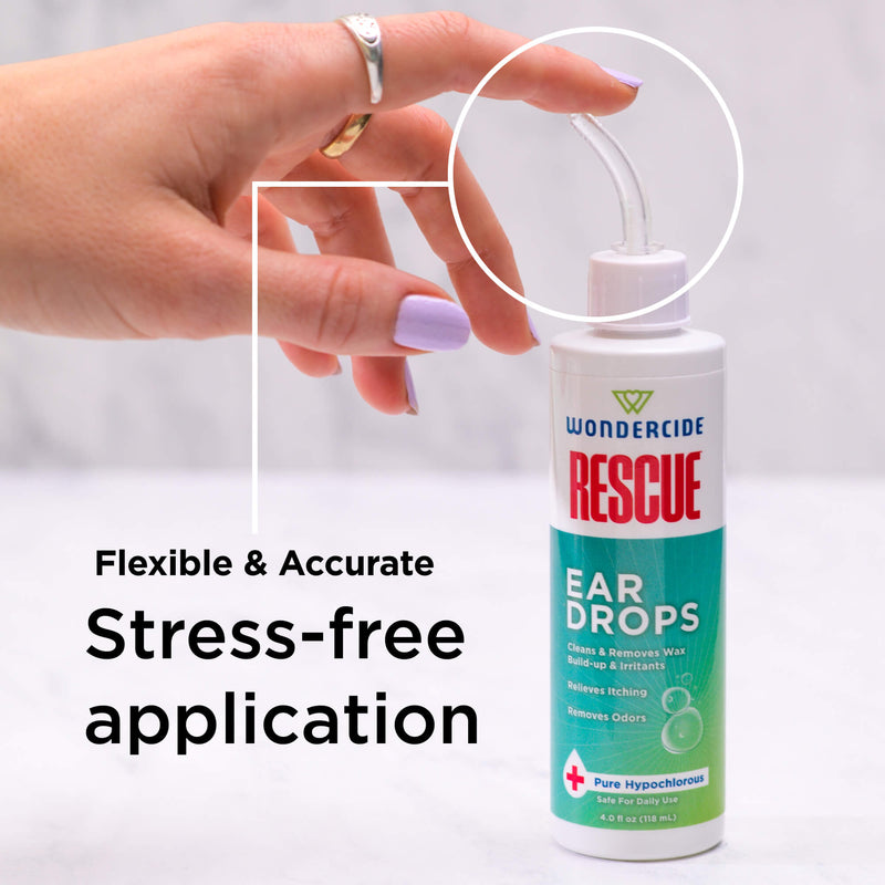 A hand holds a dropper over a bottle of Wondercide RESCUE™ Ear Drops, with "Flexible & Accurate Stress-free application" displayed—highlighting easy ear wax removal and soothing ear irritation for pets.