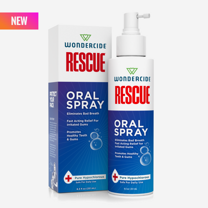 A blue and white bottle labeled Wondercide RESCUE™ Oral Spray for Dogs & Cats stands before its matching box. The oral spray uses pure hypochlorous to freshen breath and support healthy teeth and gums. A pink NEW label is at the top left corner.