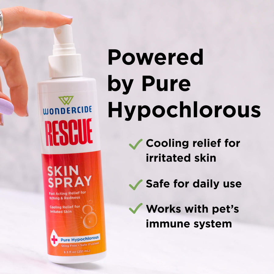A hand holds a bottle of Wondercide RESCUE™ Skin Spray. Text notes cooling relief for irritated skin, safe for sensitive areas, powered by pure hypochlorous, and supports your pet’s immune system—ideal for daily care.
