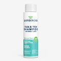 A white bottle of Wondercide Flea & Tick Shampoo for dogs and cats in cedarwood scent, with green and blue text showing it’s powered by plants and acts as a natural tick repellent.