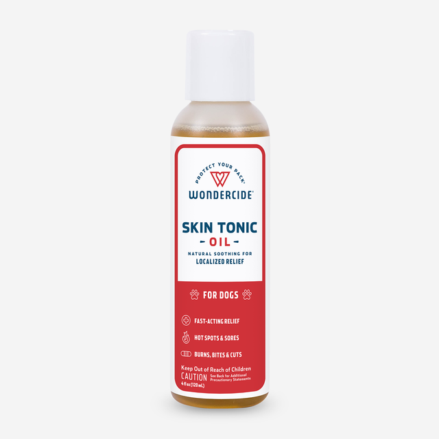 Wondercide Skin Tonic Topical Oil for Dogs, with a red and white label, contains neem oil for natural relief of burns, bites, cuts, hot spots, and sores.